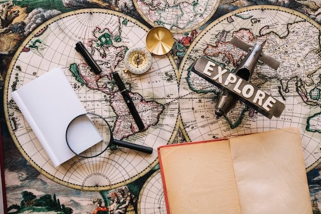 a map, compass and a journal for travelling