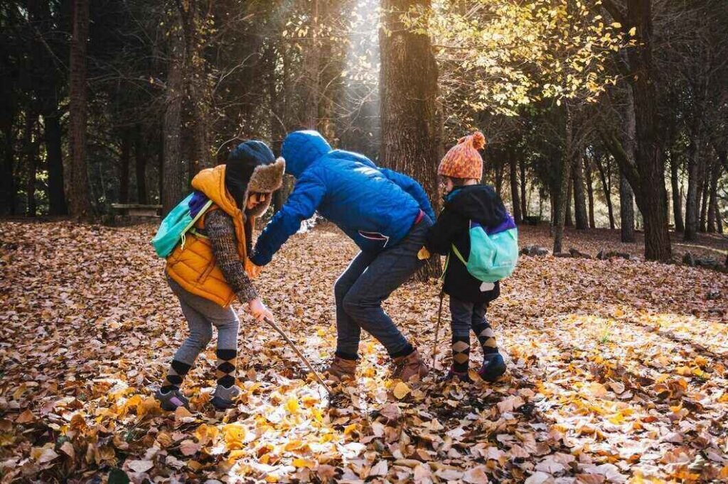 Kids enjoying seasonal adventure in the woods