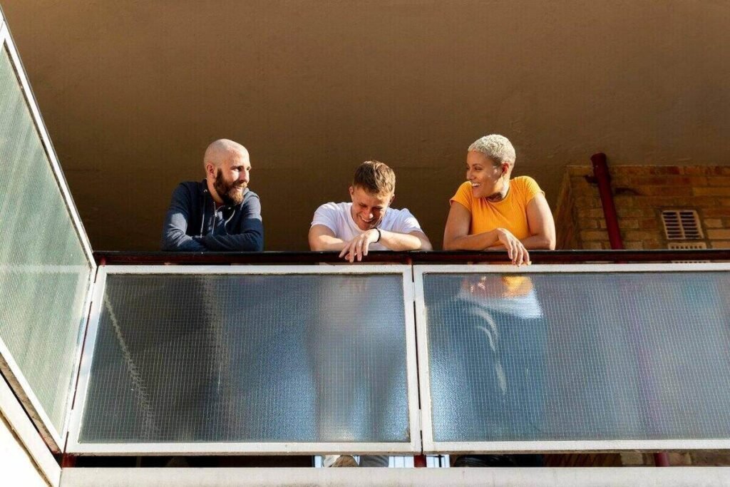 friends enjoying time together in the city on a balcony