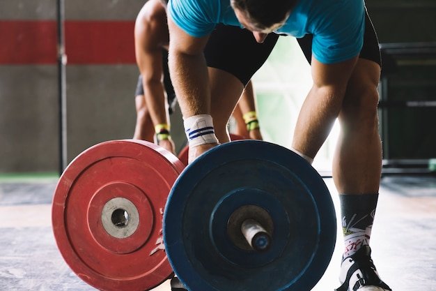 A man lifting heavy weights for his fitness routine