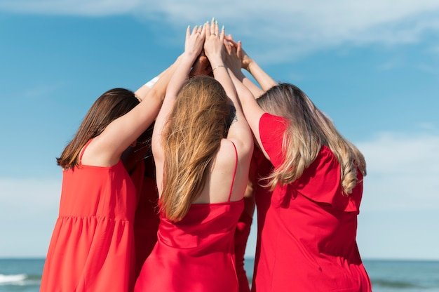 three women in a red dress feel empowered by self-love