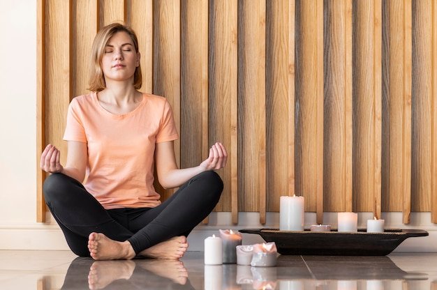 a woman peacefully meditating to be more motivational