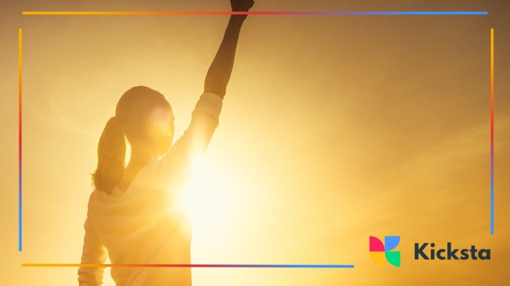 Woman raising fist in sunlight for inspiration