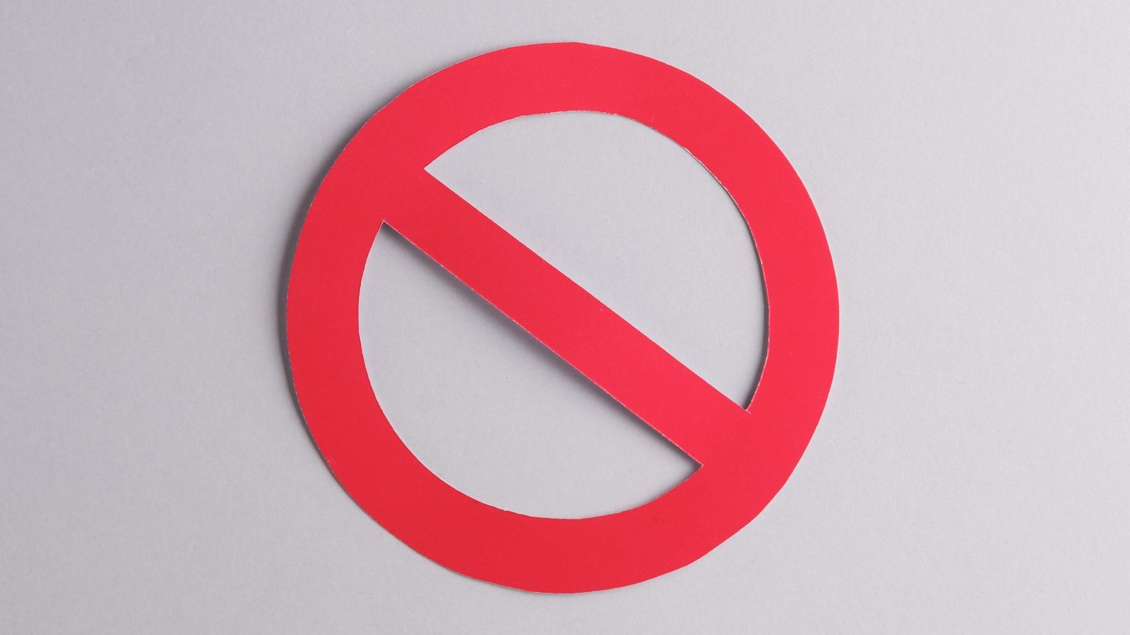 Red prohibition symbol on a gray background.