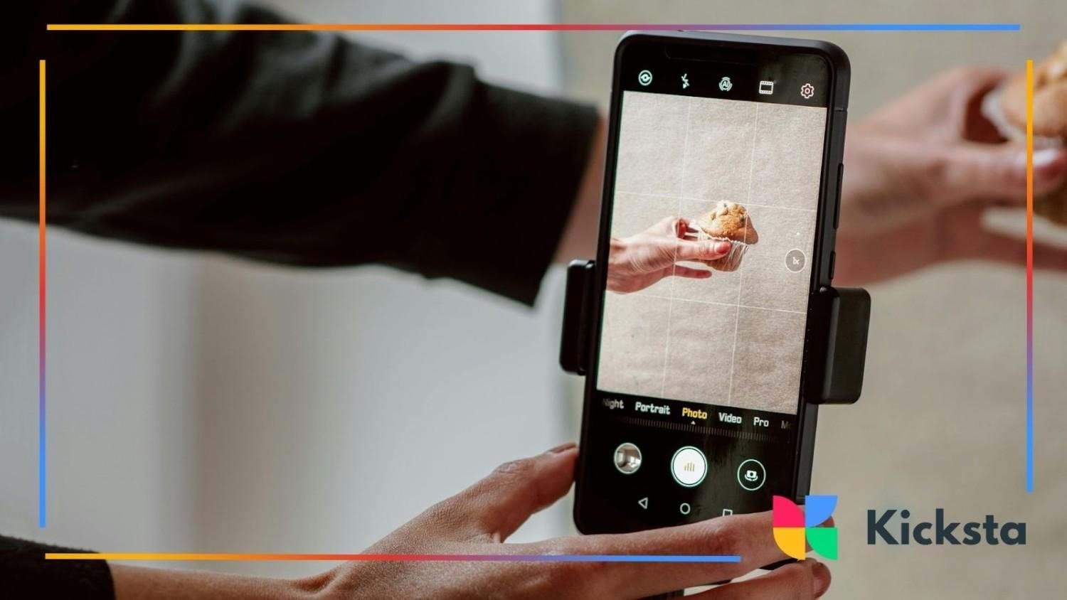 Person taking a close-up photo of a muffin with a smartphone on a tripod