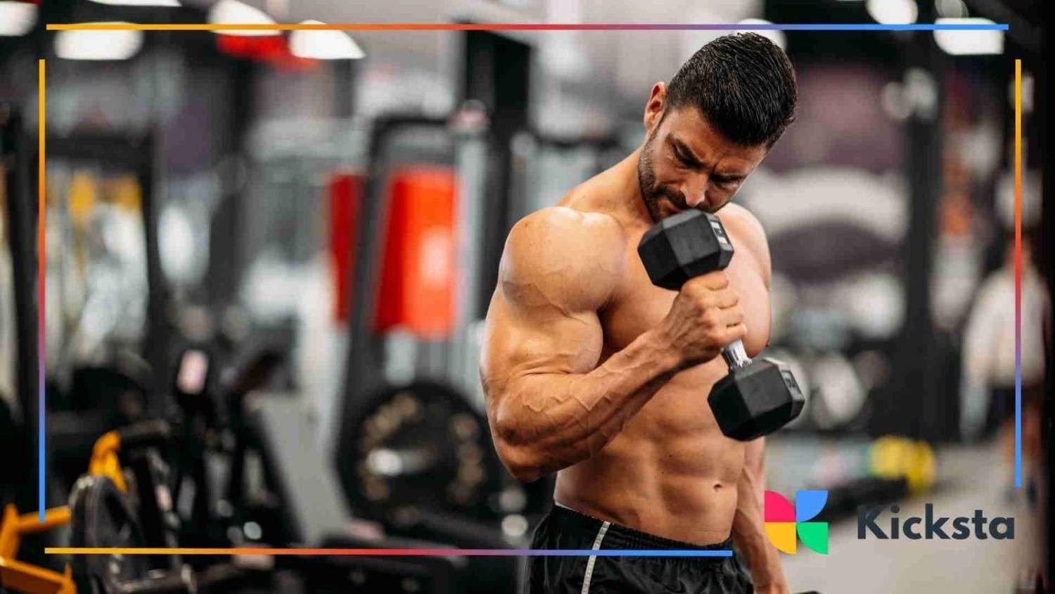 Muscular man lifting a dumbbell in a gym, focusing on his bicep workout with blurred gym equipment in the background.
