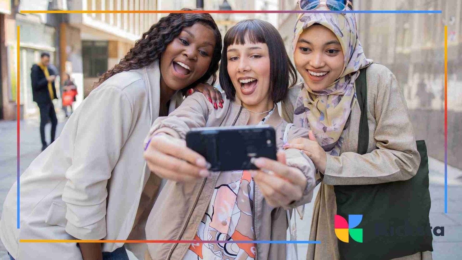 Three friends smiling and taking a selfie on the street.