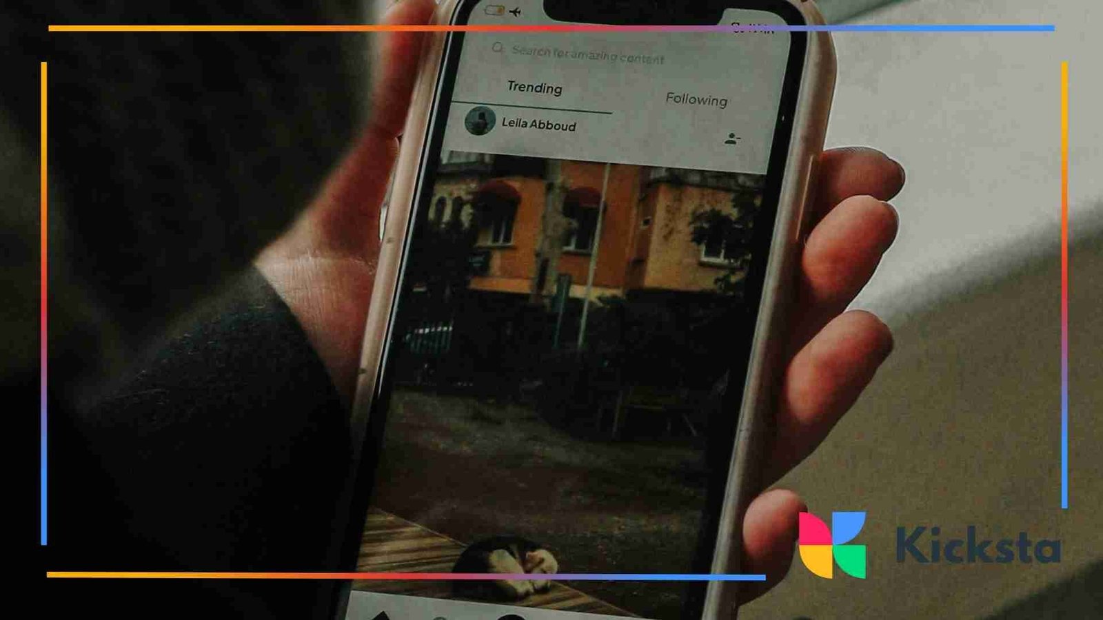 Person holding a smartphone while viewing a social media feed.