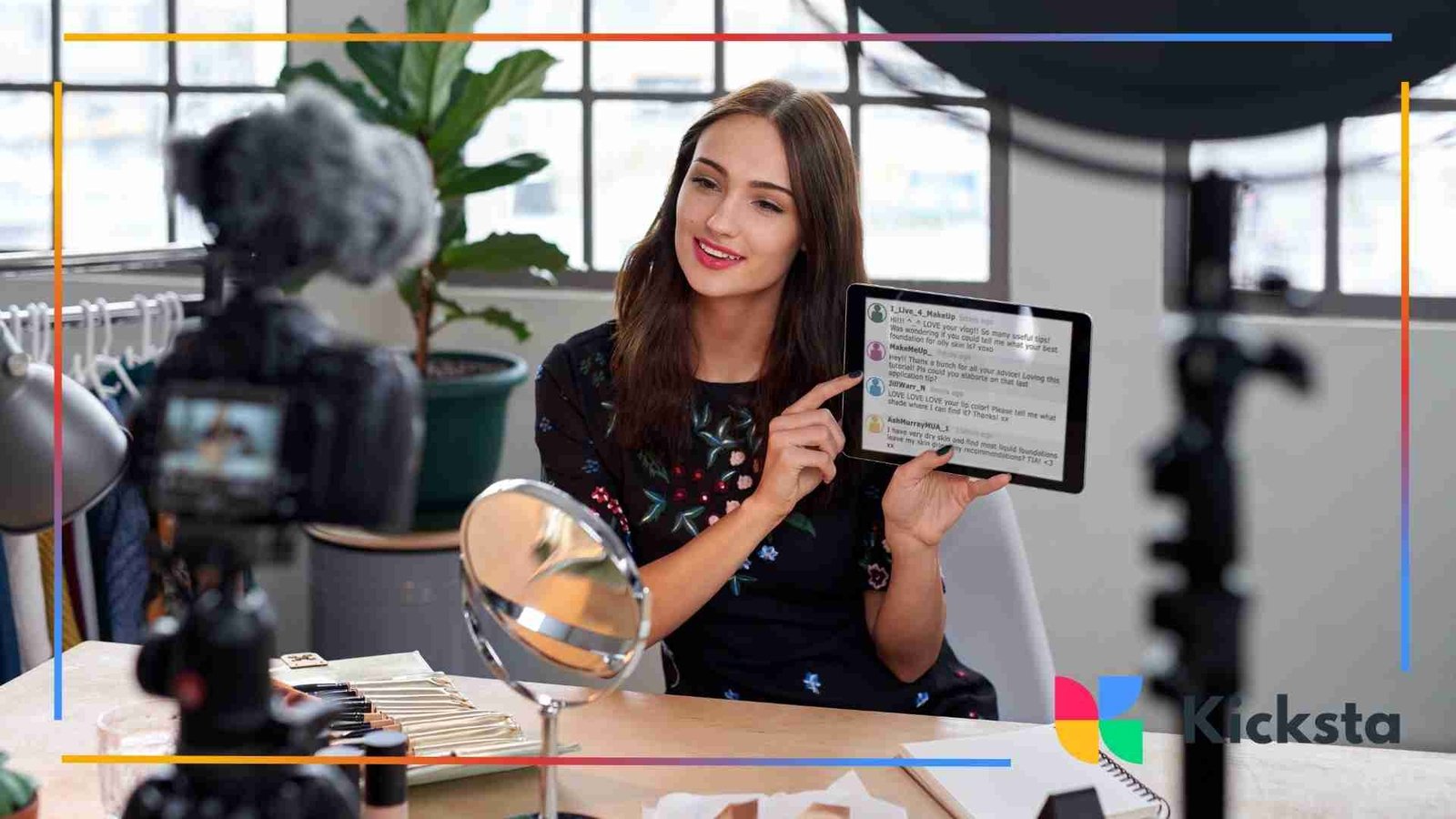 Woman recording a video while holding a tablet showing viewer comments.