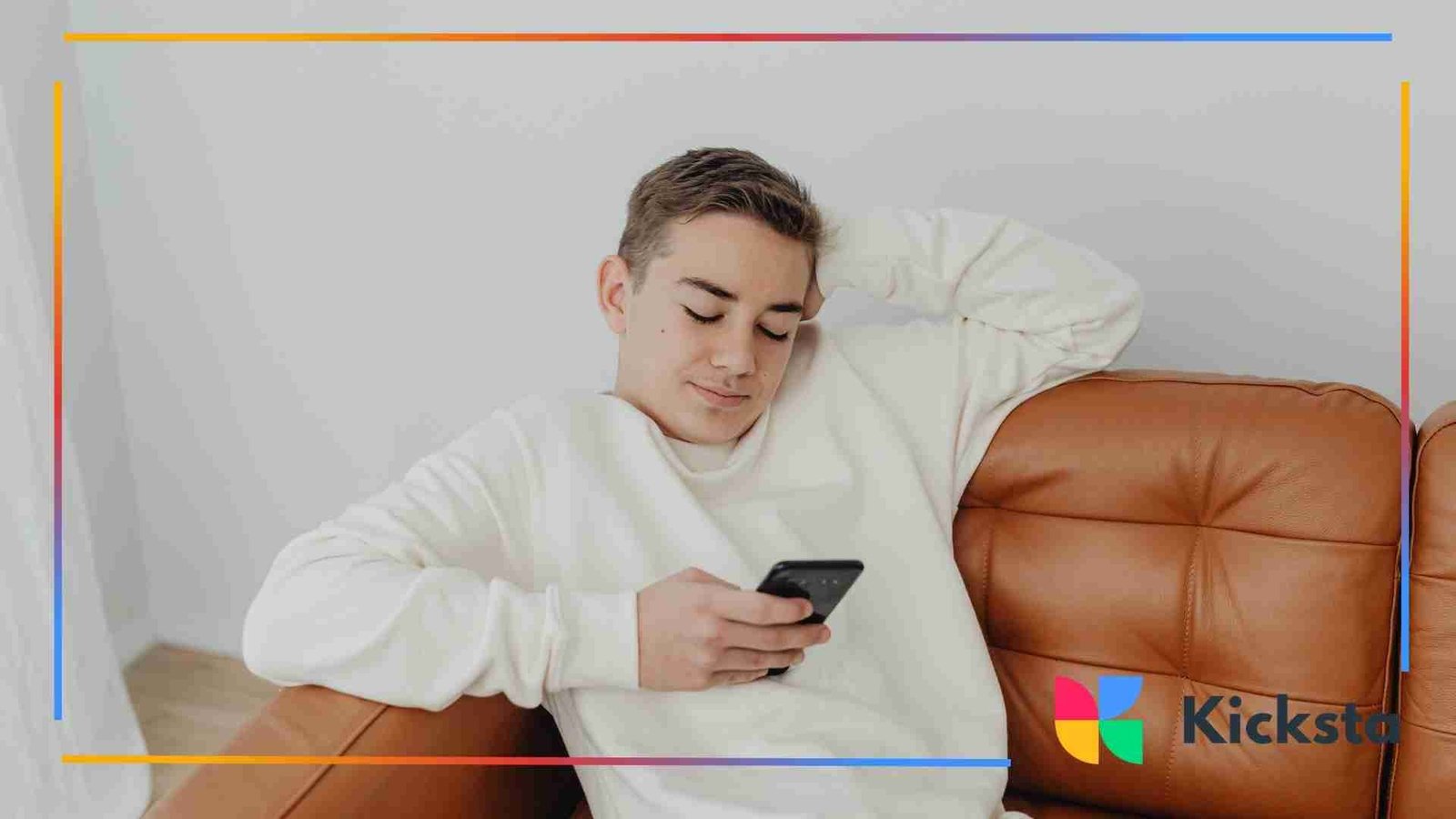 A guy in a white shirt holding a smartphone