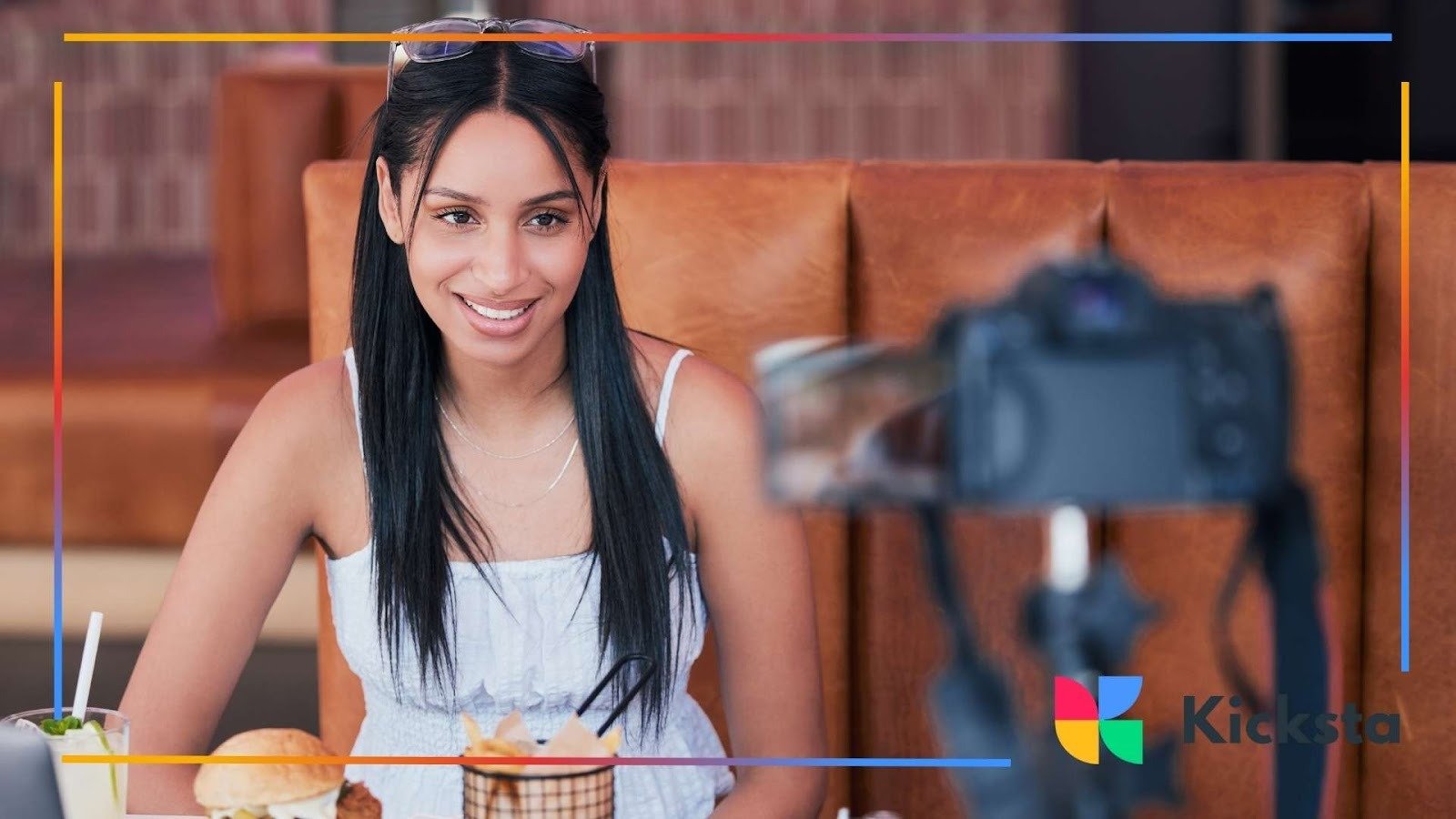Food influencer filming restaurant vlog with camera, showcasing lifestyle content, dining experience, and social media marketing.