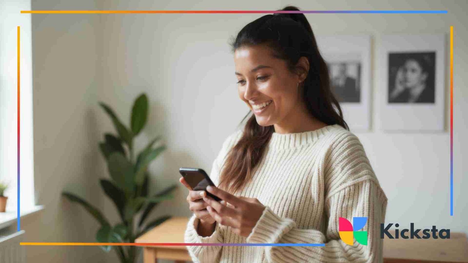 Young woman smiling while looking down at her phone inside a bright, cozy room.