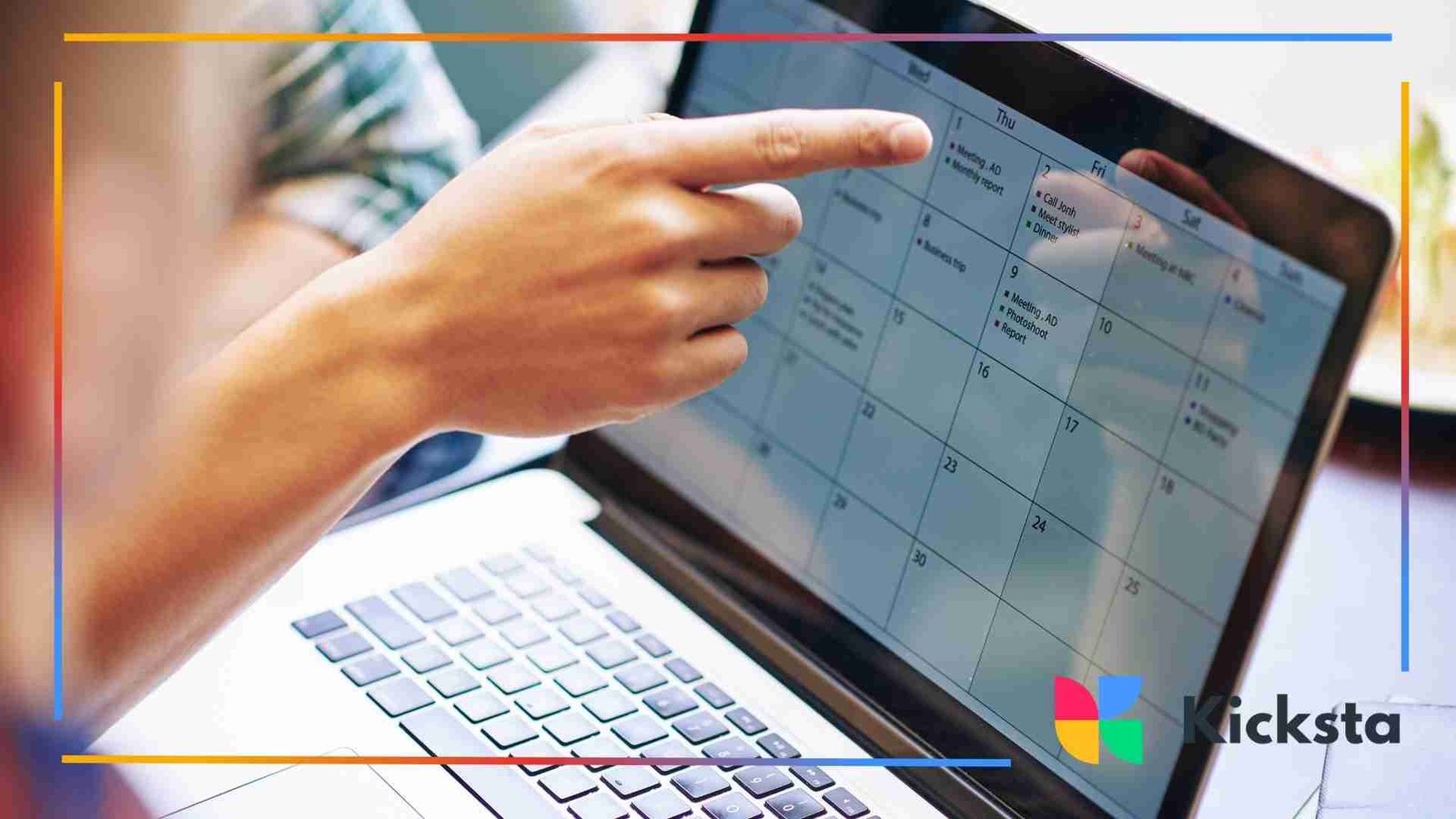 Person pointing at a digital monthly calendar displayed on a laptop screen.