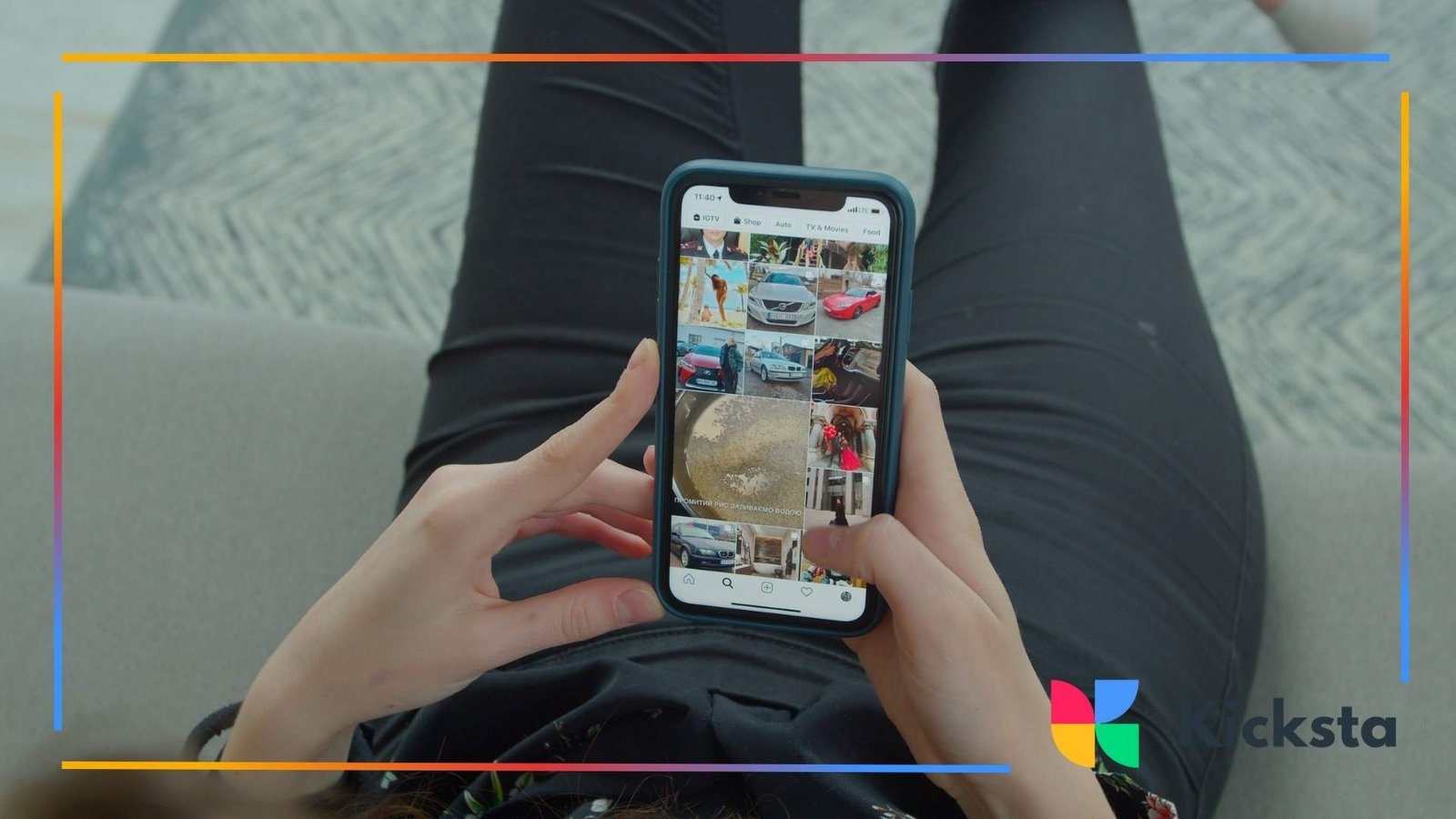 Person holding a smartphone while scrolling through an Instagram feed, viewed from above as they sit on a couch.