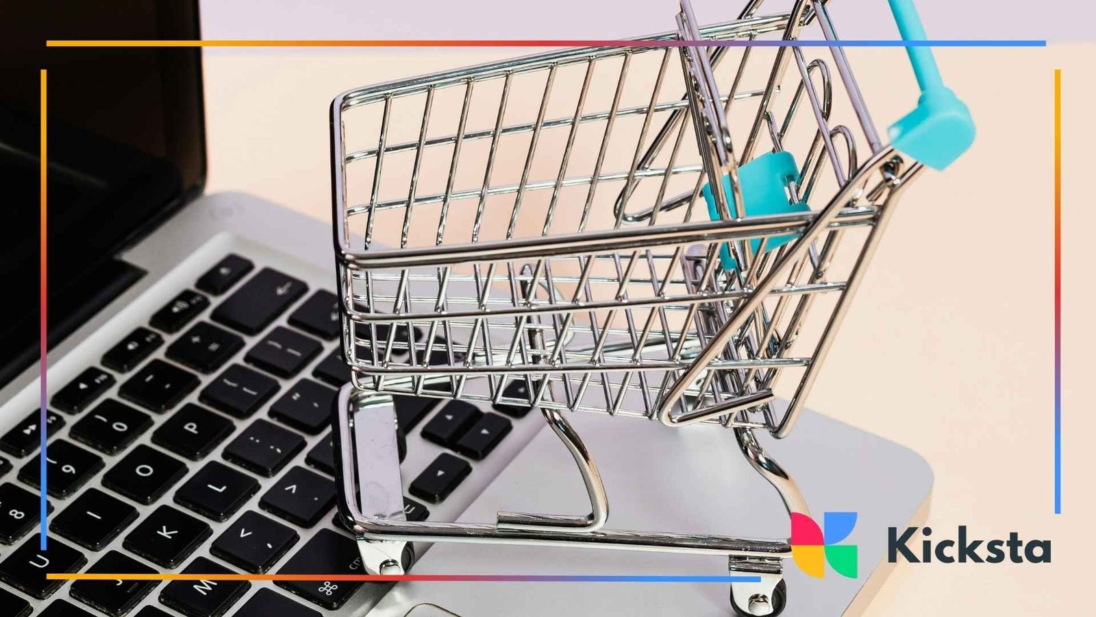 Small metal shopping cart placed on top of a laptop keyboard, representing online shopping or e-commerce.