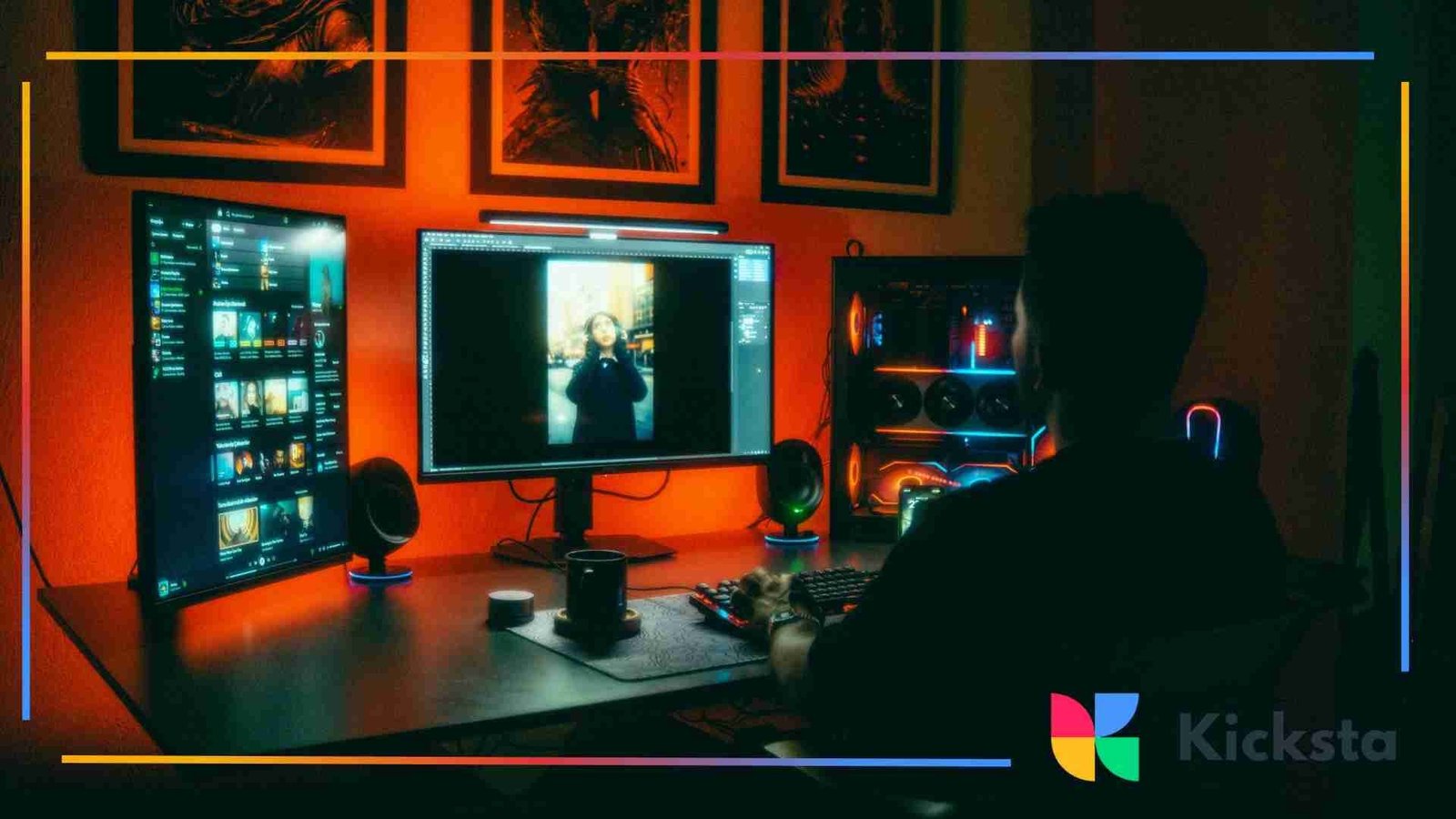 A person editing a portrait photo on a computer in a dark room illuminated by bright red and neon lights from multiple monitors and a desktop PC.