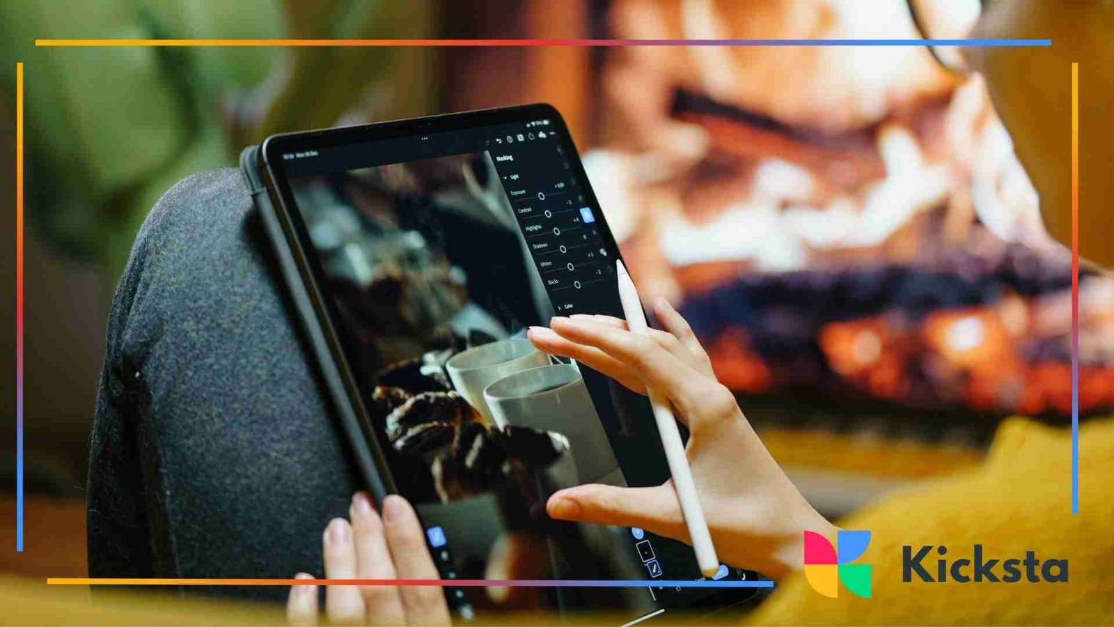 Person editing a photo on a tablet using a stylus with a warm, cozy background.