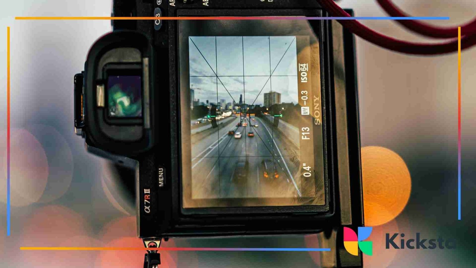 A close-up of a digital camera screen displaying a photo of a busy city highway with cars and buildings in the distance.