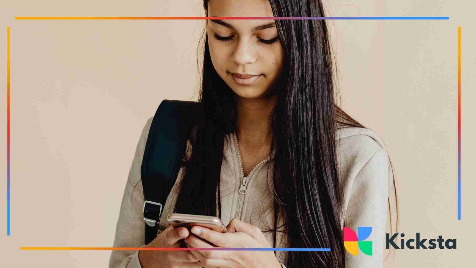 Teenage girl looking down at her phone while wearing a backpack.