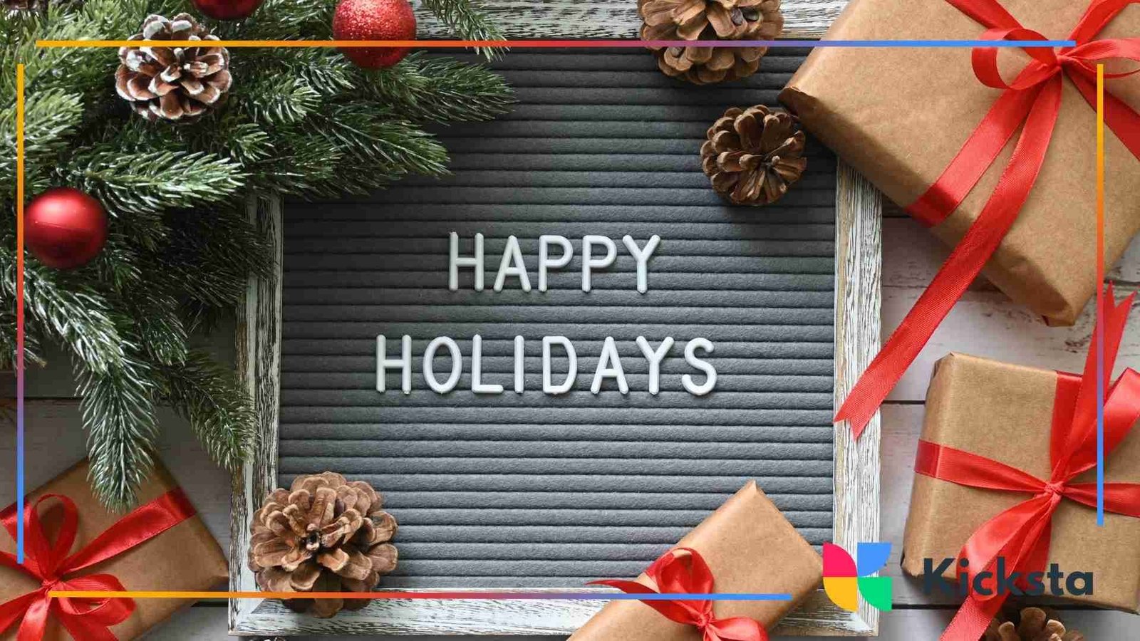 Flat lay of wrapped holiday gifts, pine branches, pinecones, and a letter board reading “Happy Holidays.”
