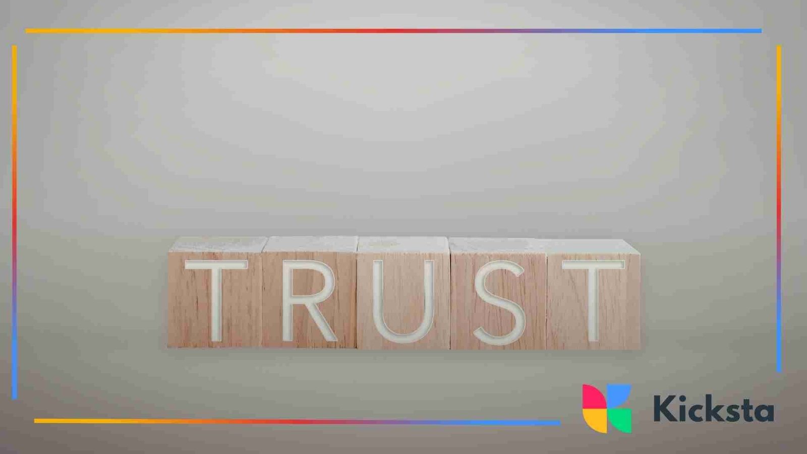 Wooden blocks arranged to spell the word “trust” on a neutral background.