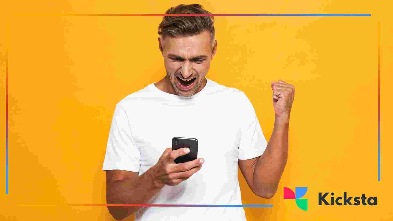 Person smiling and raising a fist while looking at a smartphone against a yellow background.